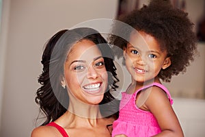 Mother Cuddling Daughter At Home