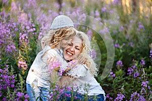 Mother and a cute little son hugging and having fun in the fild with flowers in summer. Family and happiness consept