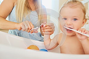 Mother cutting nails with scissors to the baby.