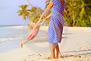 Mother and daugher playing on beach