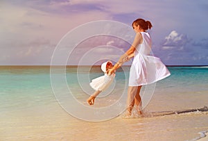 Mother and daugher playing on summer beach