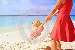 Mother and daugher playing on summer beach