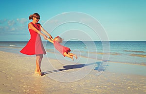 Mother and daugher playing on tropical beach