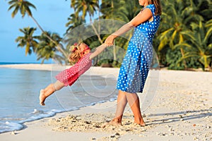 Mother and daugher playing on beach