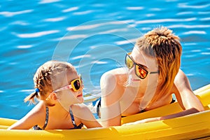 Mother and daughter on airbed