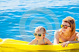 Mother and daughter on airbed