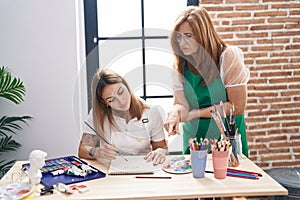 Mother and daughter artists having draw class at art studio