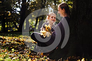 Mother with daughter in the autumn park