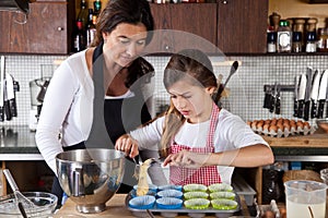Mother and daughter baking at home photo