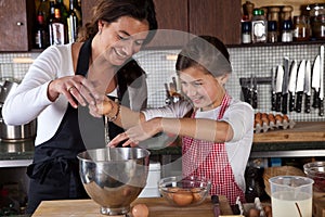 Mother and daughter baking in the kitchen