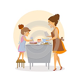 Mother and daughter baking together cakes in the kitchen at home