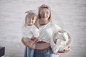 Mother and daughter in a bathroom near wash mashine