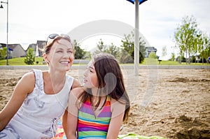 Mother and daughter at the beach talking