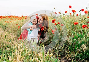 Mother and daughter in beautiful poppy field