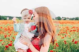 Mother and daughter in beautiful poppy field