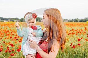 Mother and daughter in beautiful poppy field