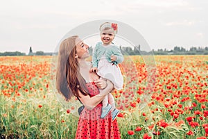 Mother and daughter in beautiful poppy field