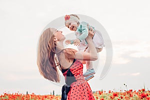 Mother and daughter in beautiful poppy field