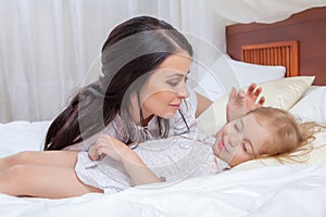 Mother and daughter in bed