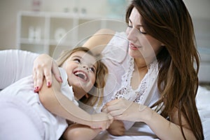 Mother and daughter in the bed together. photo