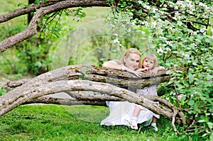 Mother and daughter in blooming garden