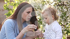 Mother and daughter blow bubbles