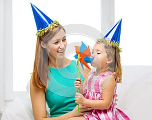 Mother and daughter in blue hats with pinwheel