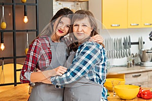 Mother daughter bond hugging kitchen time fun