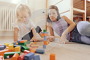 Mother and daughter build, invent with wooden blocks