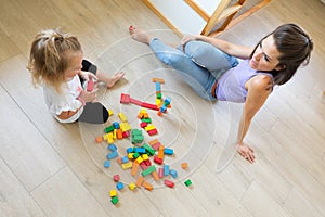 Mother and daughter build, invent with wooden blocks
