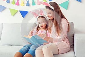 Mother and daughter in bunny ears together weekend at home sitting