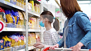 Mother and daughter buying pasta at grocery store during pandemic