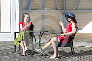 Mother and daughter chatting in the terrace