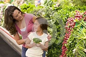 Mother and daughter choosing fresh produce