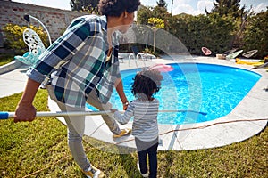 Mother and Daughter Cleaning the Pool with Dedication