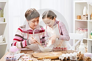Mother and daughter cooking and having fun, home kitchen interior, healthy food concept