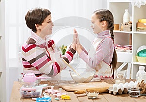 Mother and daughter cooking and having fun, home kitchen interior, healthy food concept