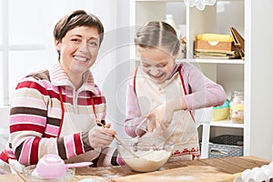 Mother and daughter cooking and having fun, home kitchen interior, healthy food concept