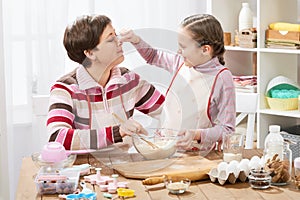 Mother and daughter cooking and having fun, home kitchen interior, healthy food concept