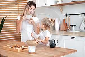 Mother and daughter Cooking in kitchen. Happiness Cooking Activity Concept