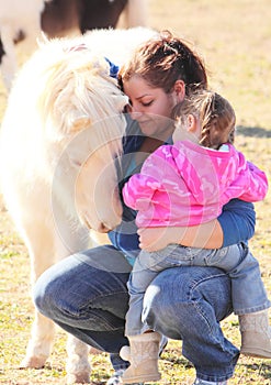 Mother and Daughter Cuddle Miniature Horse