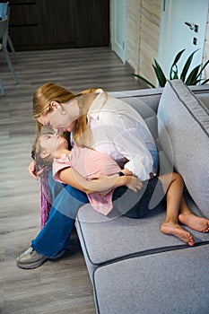 Mother and daughter cuddling and hugging, having fun