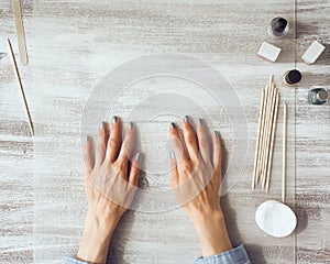 Mother and daughter do manicure, paint nails with varnish. Home self-care during quarantine