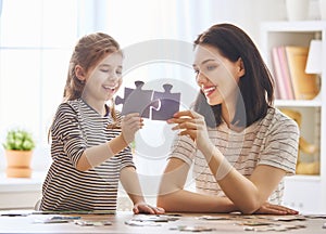 Mother and daughter do puzzles