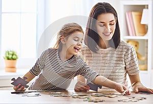 Mother and daughter do puzzles