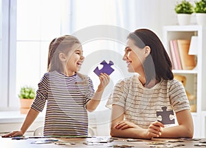 Mother and daughter do puzzles