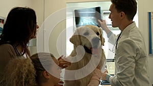 Mother and daughter with dog in the vets