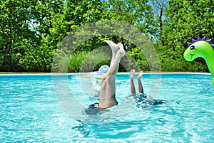 Mother and daughter doing handstands in the pool