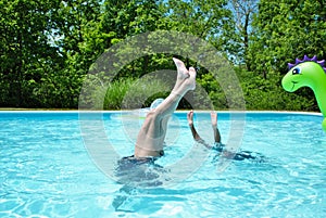 Mother and daughter doing handstands in the pool