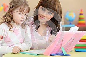 Mother with daughter doing homework